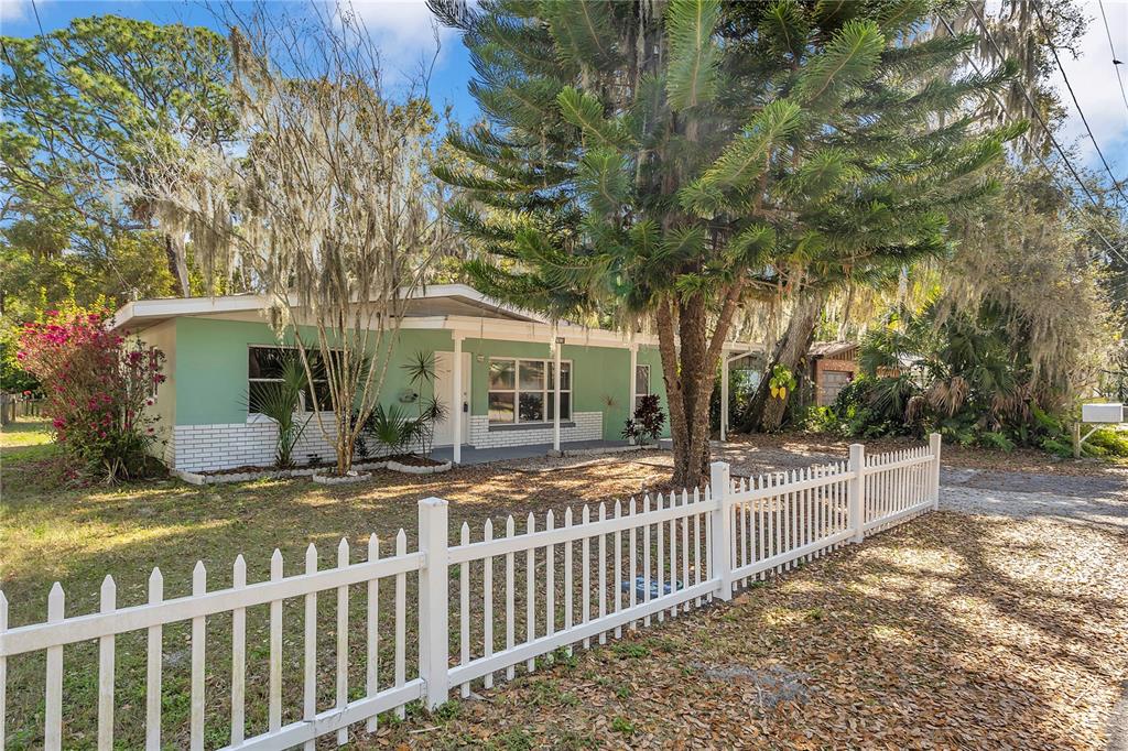7822 Chasco Street Port Richey, FL 34668 - Photo 1 of 1 a view of a house with a wooden fence