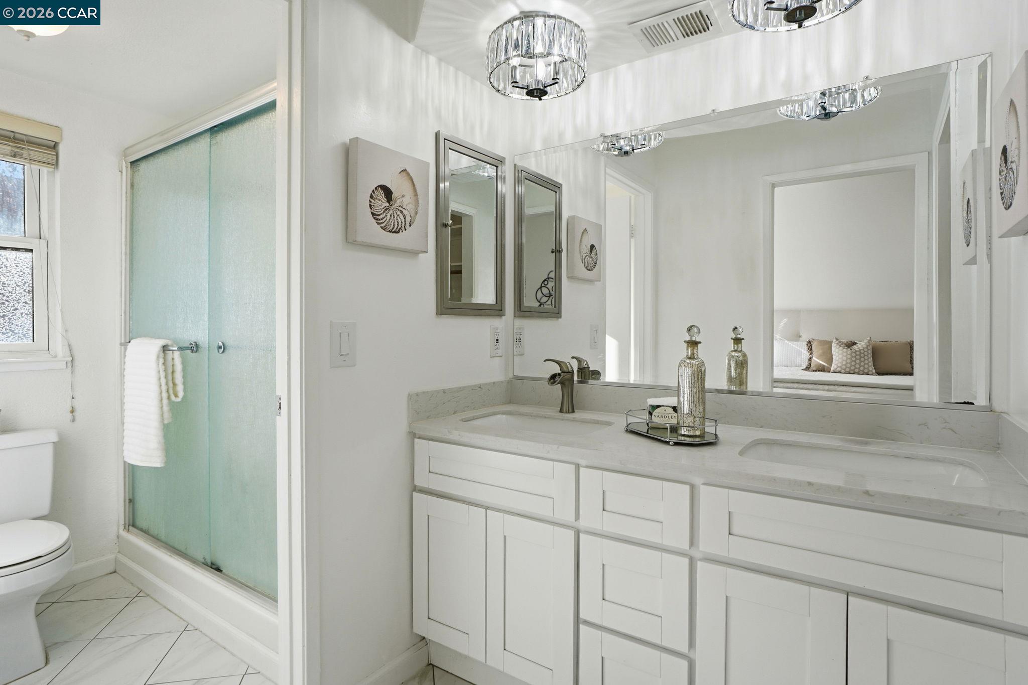 1255 Detroit Avenue, Unit 3 Concord, CA 94520 - Photo 14 of 30 a bathroom with a granite countertop sink a toilet and a mirror