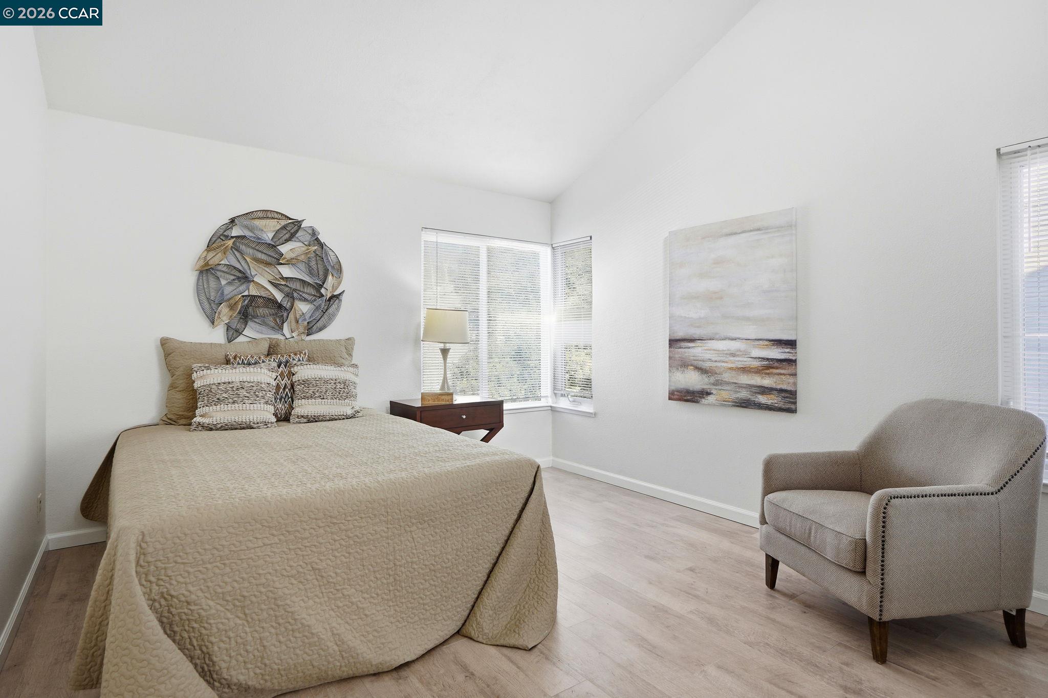 1255 Detroit Avenue, Unit 3 Concord, CA 94520 - Photo 18 of 30 a bedroom with a large bed a couch and a window