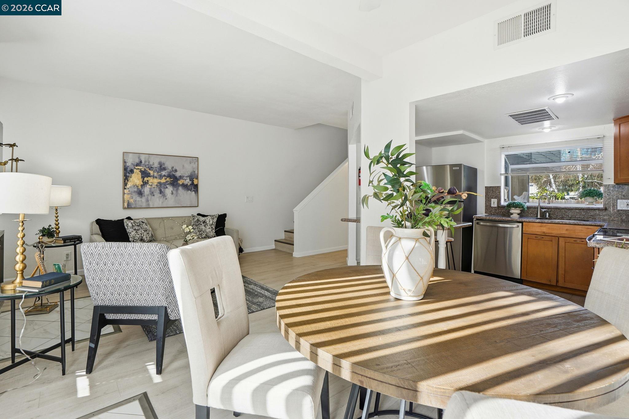 1255 Detroit Avenue, Unit 3 Concord, CA 94520 - Photo 7 of 30 a dining room with furniture and wooden floor