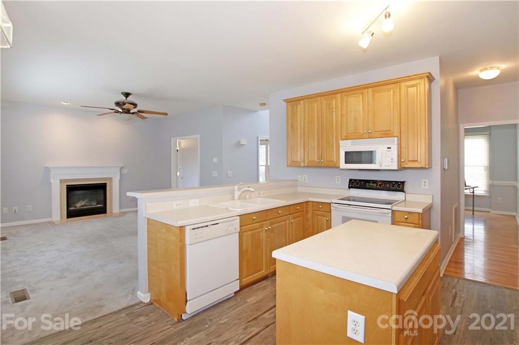 10402 Friarsgate Road Huntersville, NC 28078 - Photo 15 of 46 a kitchen with a stove a sink and a refrigerator