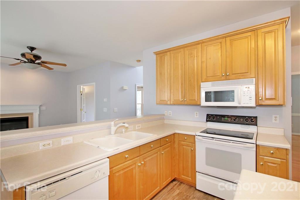 10402 Friarsgate Road Huntersville, NC 28078 - Photo 17 of 46 a kitchen with a sink stove top oven and cabinets