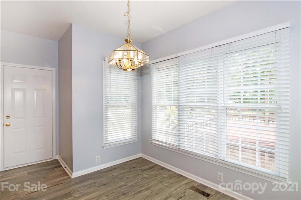 10402 Friarsgate Road Huntersville, NC 28078 - Photo 19 of 46 a view of an empty room with wooden floor and a window