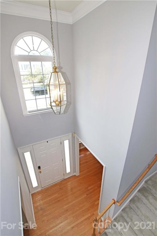 10402 Friarsgate Road Huntersville, NC 28078 - Photo 21 of 46 a view of staircase with white walls and a window