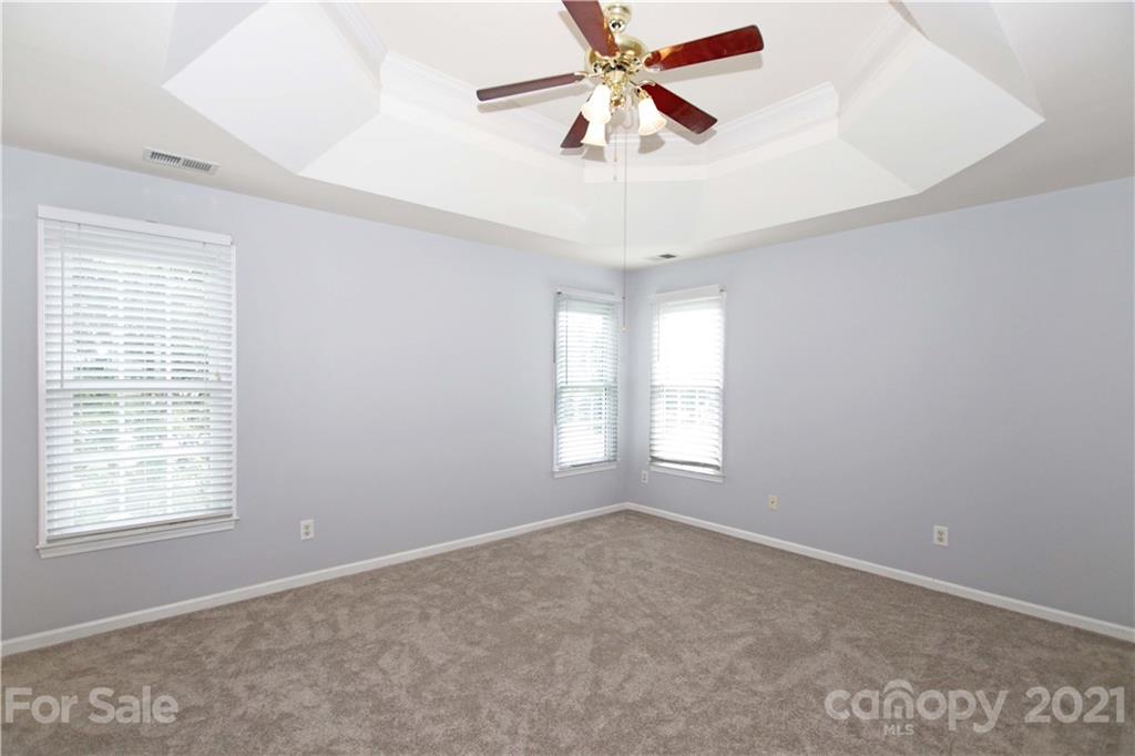 10402 Friarsgate Road Huntersville, NC 28078 - Photo 22 of 46 a view of a room with windows and ceiling fan