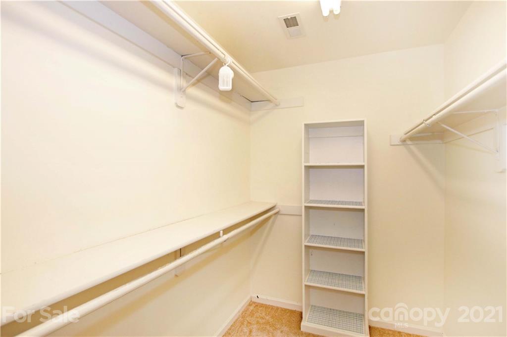 10402 Friarsgate Road Huntersville, NC 28078 - Photo 27 of 46 a view of walk in closet with empty racks