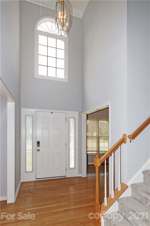 10402 Friarsgate Road Huntersville, NC 28078 - Photo 4 of 46 a view of empty room with wooden floor and fan