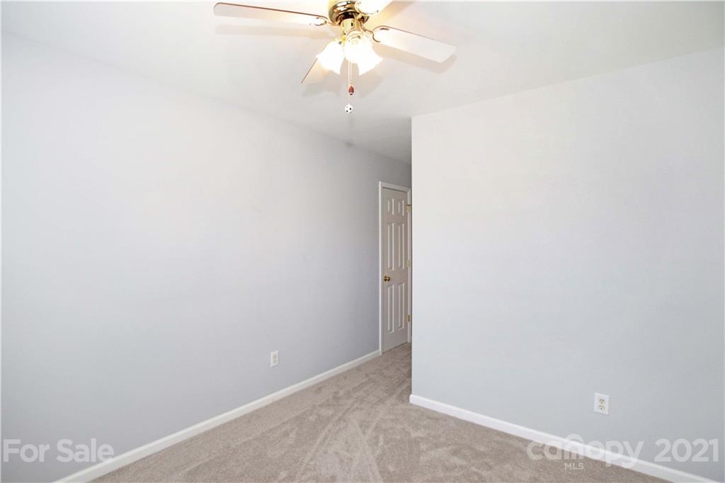 10402 Friarsgate Road Huntersville, NC 28078 - Photo 31 of 46 an empty room with a window and a fan