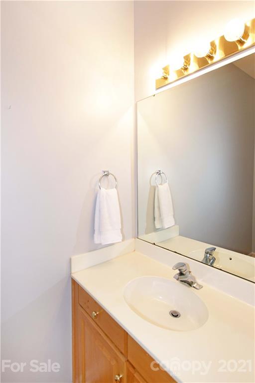 10402 Friarsgate Road Huntersville, NC 28078 - Photo 33 of 46 a bathroom with a sink and mirror
