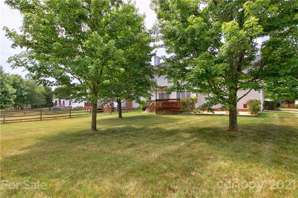 10402 Friarsgate Road Huntersville, NC 28078 - Photo 40 of 46 a view of swimming pool with trees and wooden fence