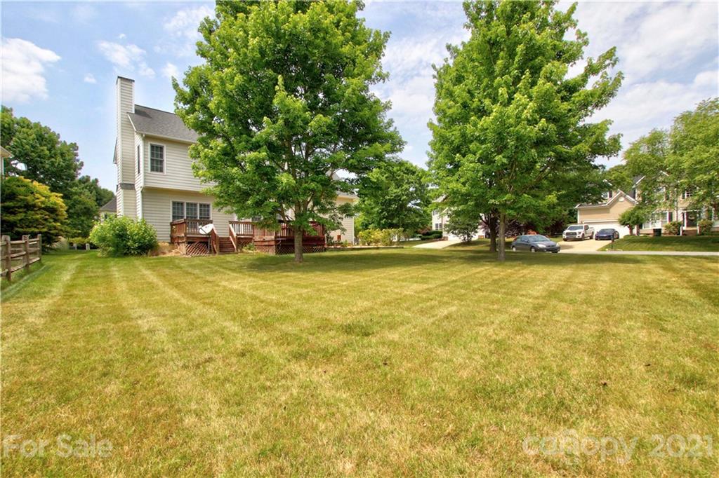 10402 Friarsgate Road Huntersville, NC 28078 - Photo 43 of 46 a view of a swimming pool and trees in the background