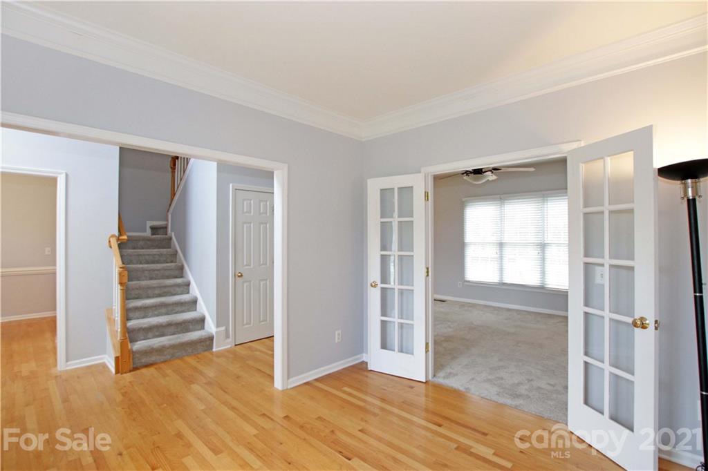 10402 Friarsgate Road Huntersville, NC 28078 - Photo 9 of 46 a view of a room with wooden floor and stairs