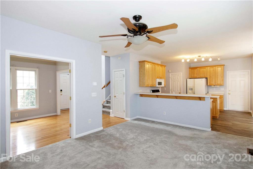 10402 Friarsgate Road Huntersville, NC 28078 - Photo 10 of 46 a view of a living room with wooden floor and a window