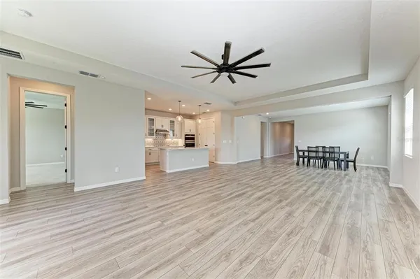 a view of a livingroom with a furniture wooden floor and a ceiling fan