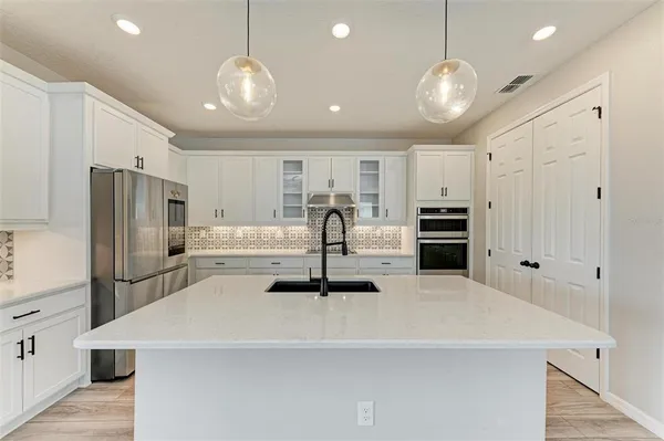 a kitchen with stainless steel appliances a refrigerator and a stove