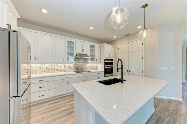 a kitchen with stainless steel appliances a stove sink and cabinets