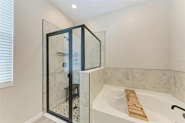 a bathroom with a tub and shower