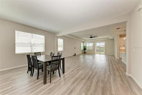 a view of a dining room with furniture and wooden floor