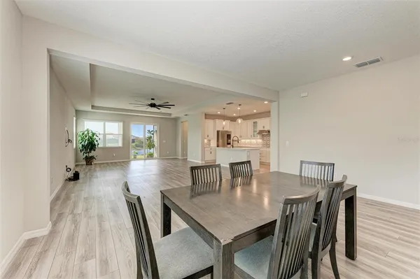 a view of a dining room with furniture and wooden floor