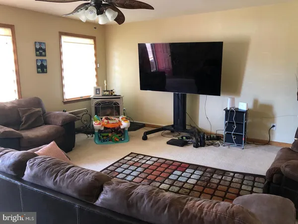 a bedroom with furniture and a flat screen tv