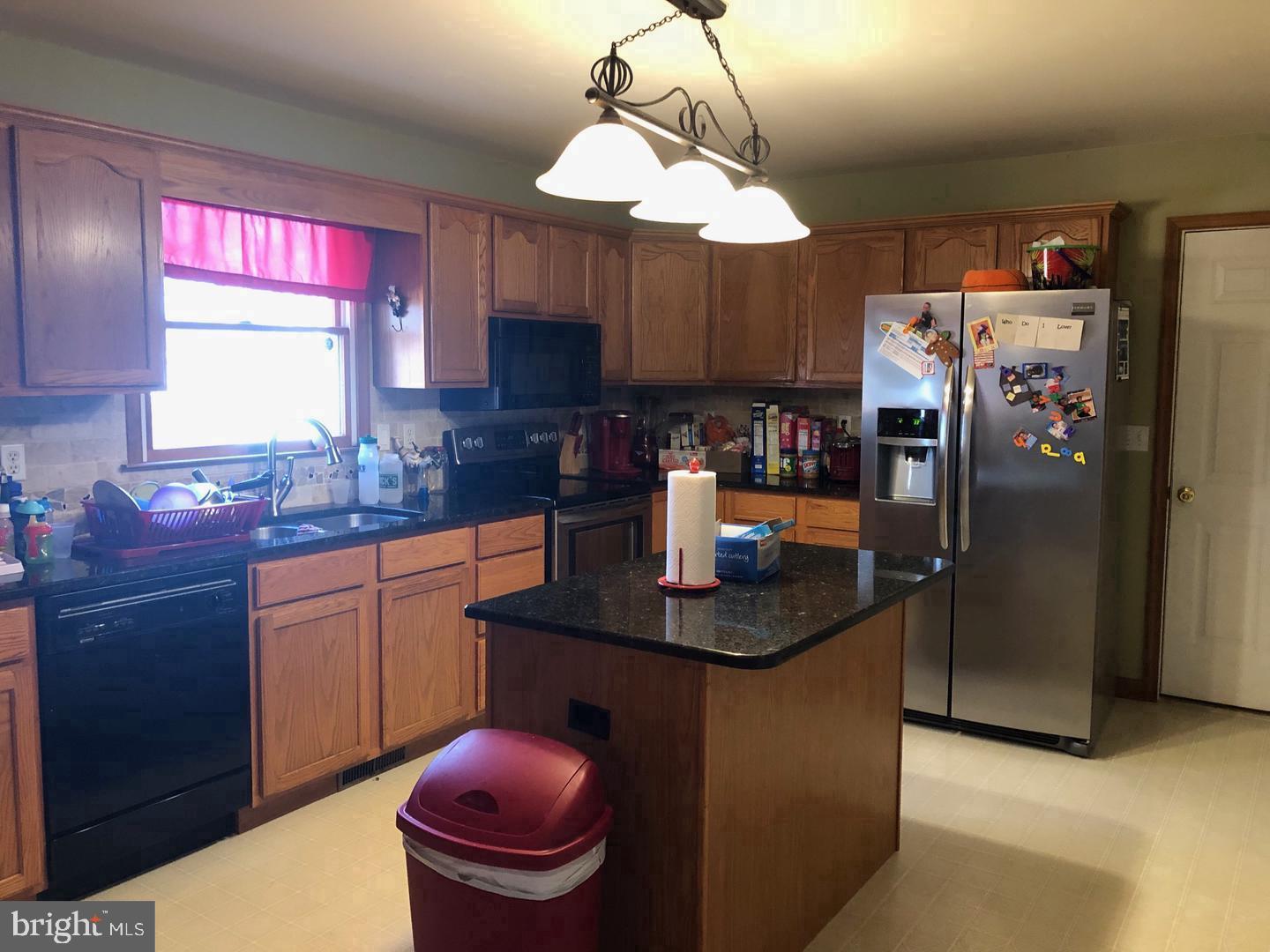 45636 Rutherford Boulevard Great Mills, MD 20634 - Photo 5 of 15 a kitchen with stainless steel appliances granite countertop a sink a refrigerator and a wooden floors