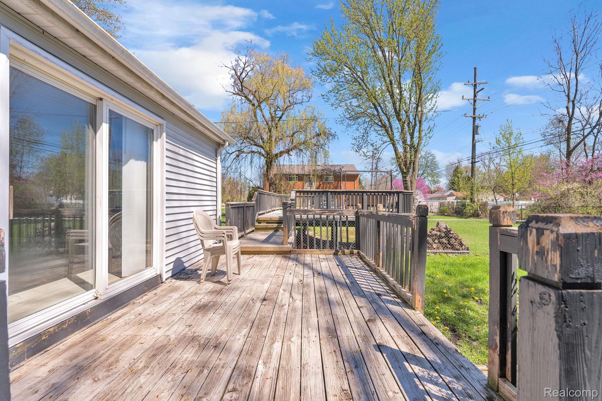 36845 Sibley Road New Boston, MI 48164 - Photo 7 of 22 Wooden terrace featuring a lawn