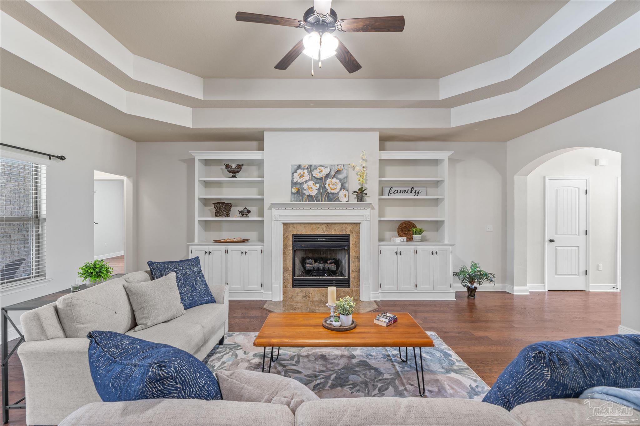2698 Tulip Hill Road Pace, FL 32571 - Photo 16 of 65 a living room with furniture and a fireplace