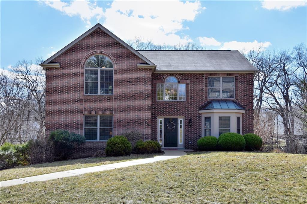a view of a brick house with a yard