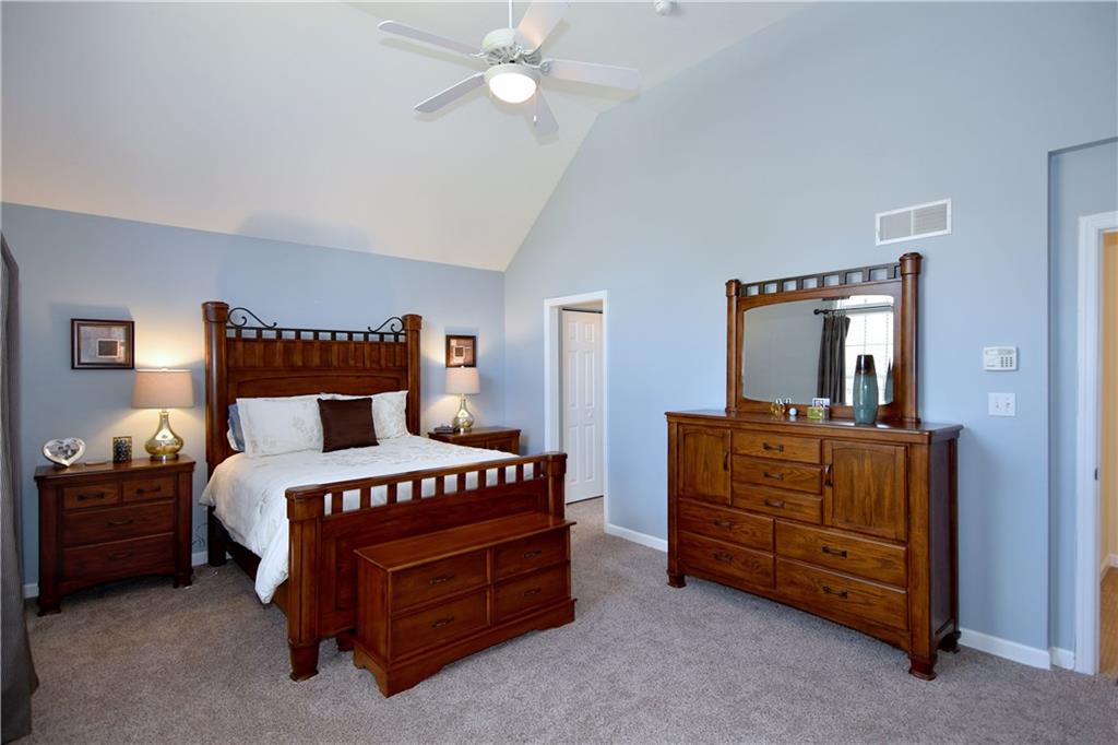 107 Beacon Hill Drive Cranberry Township, PA 16066 - Photo 13 of 25 a bedroom with a bed and a chandelier