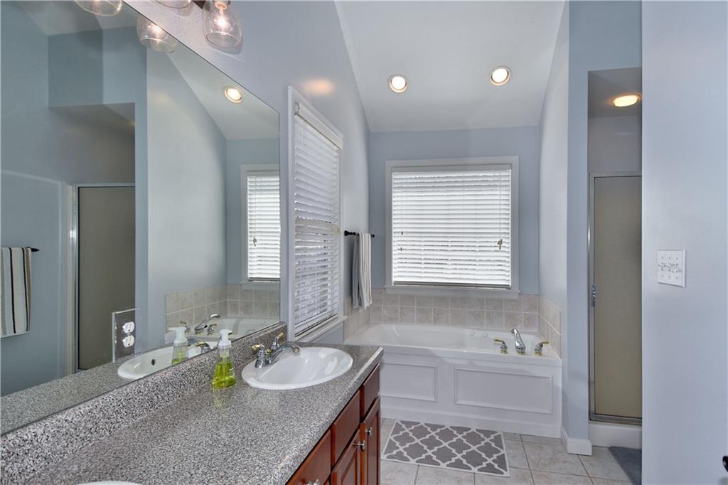 107 Beacon Hill Drive Cranberry Township, PA 16066 - Photo 14 of 25 a bathroom with a granite countertop sink and a bathtub