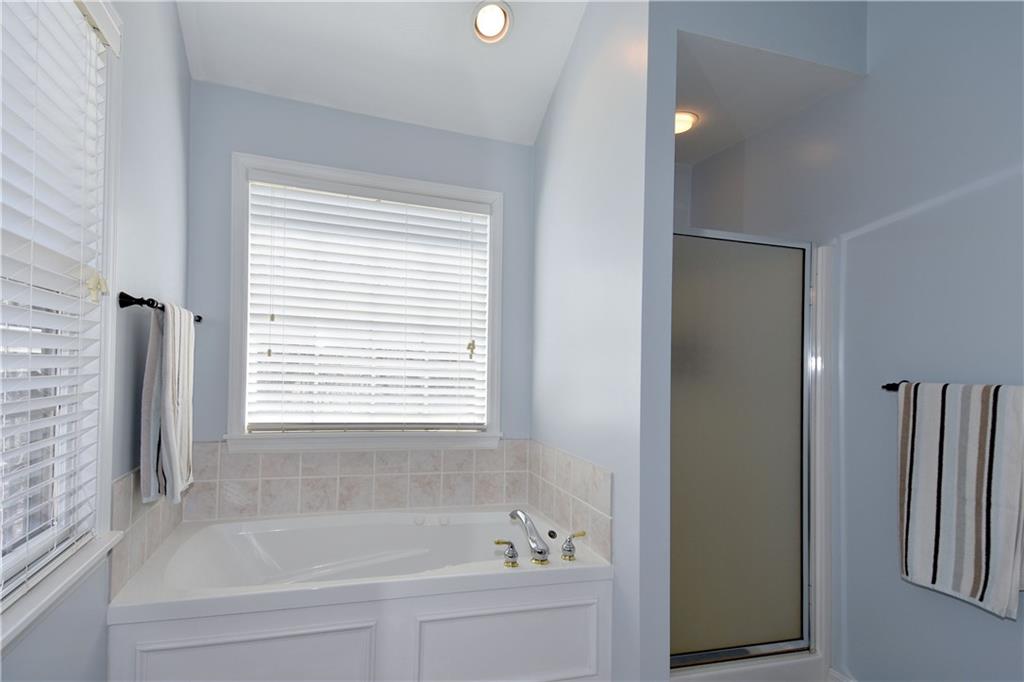 107 Beacon Hill Drive Cranberry Township, PA 16066 - Photo 16 of 25 a white bath tub sitting next to a window