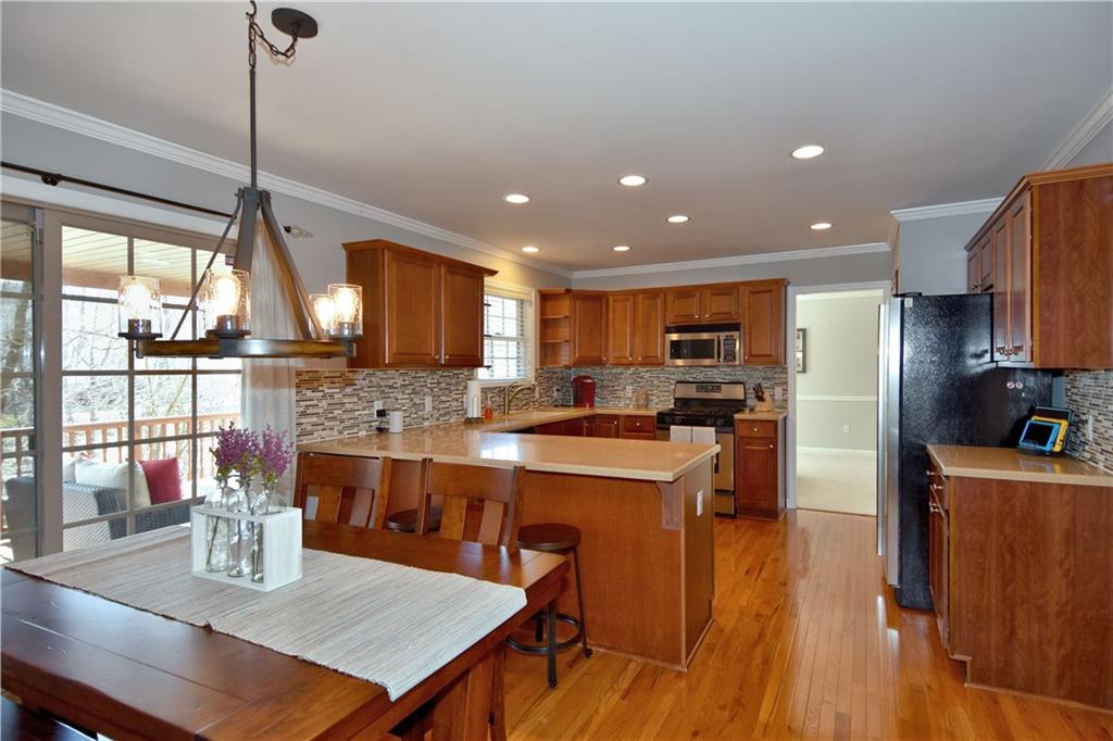 107 Beacon Hill Drive Cranberry Township, PA 16066 - Photo 5 of 25 a kitchen with stainless steel appliances granite countertop sink stove top oven and cabinets