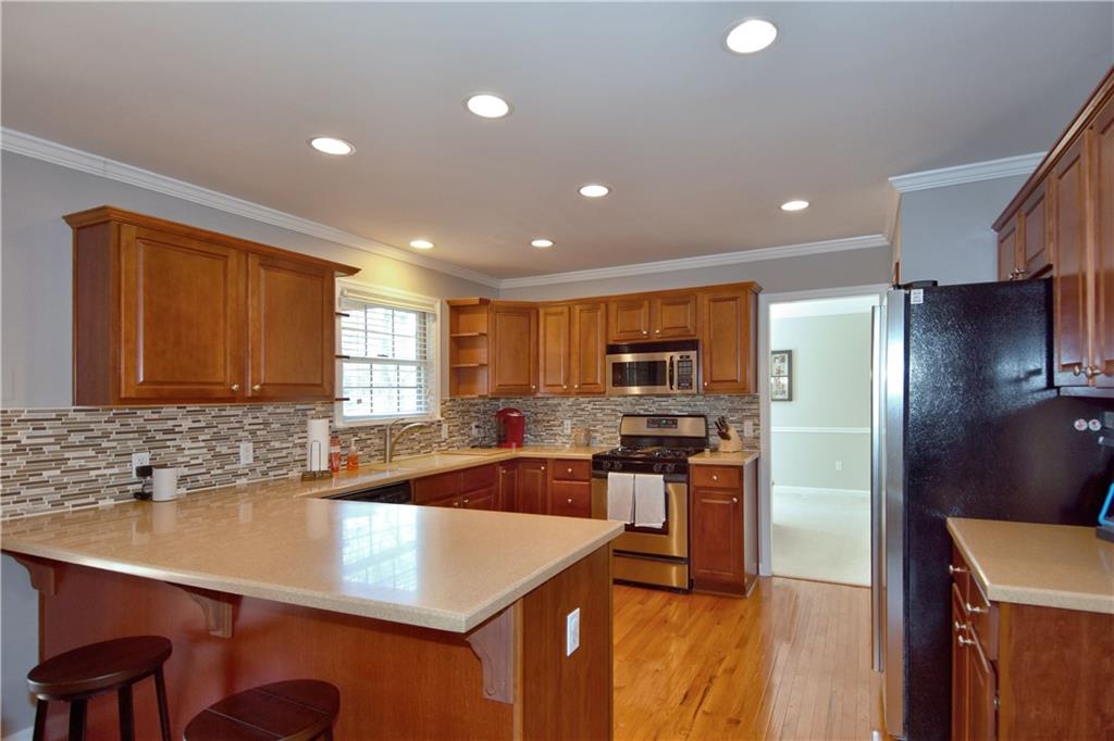 107 Beacon Hill Drive Cranberry Township, PA 16066 - Photo 6 of 25 a kitchen with stainless steel appliances granite countertop a sink a stove and a refrigerator