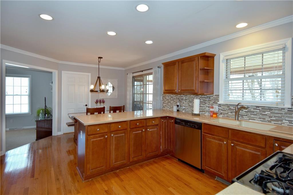 107 Beacon Hill Drive Cranberry Township, PA 16066 - Photo 7 of 25 a large kitchen with stainless steel appliances granite countertop a sink and wooden floor