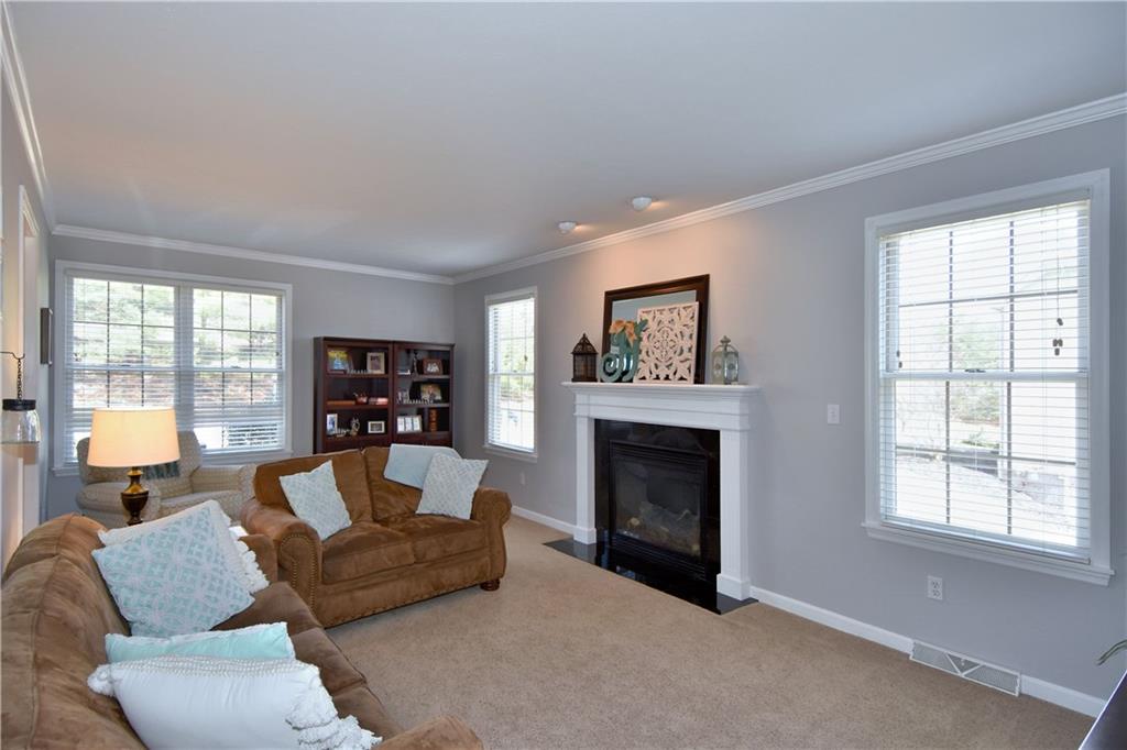 107 Beacon Hill Drive Cranberry Township, PA 16066 - Photo 8 of 25 a living room with furniture window and a fireplace