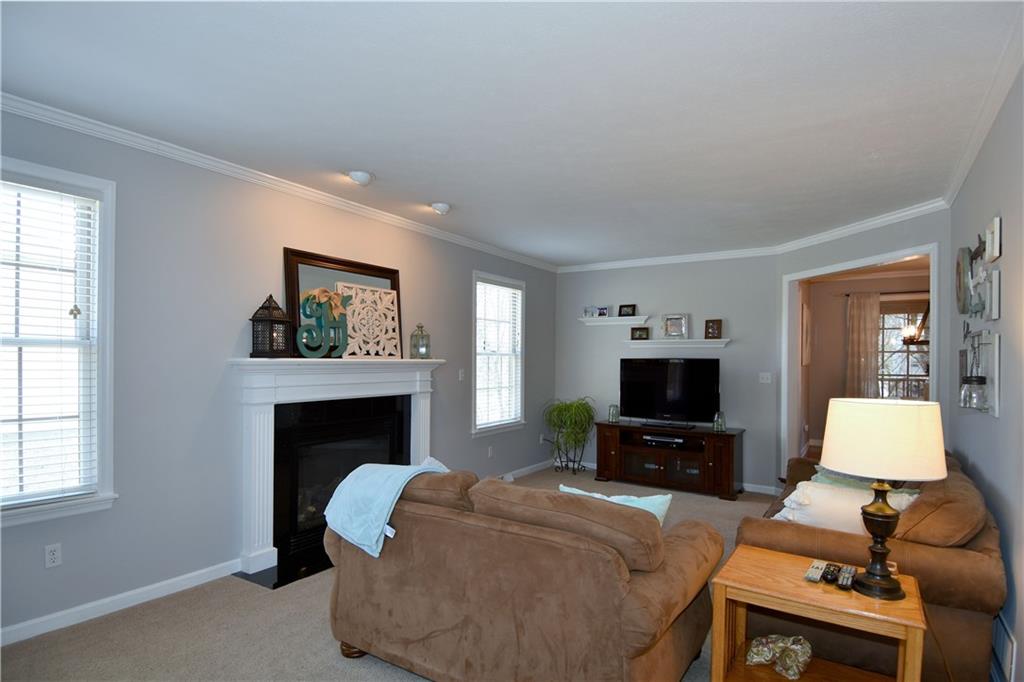 107 Beacon Hill Drive Cranberry Township, PA 16066 - Photo 10 of 25 a living room with furniture a fireplace and a flat screen tv