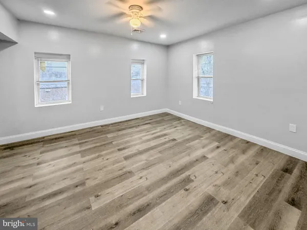 a view of an empty room with a window and closet area