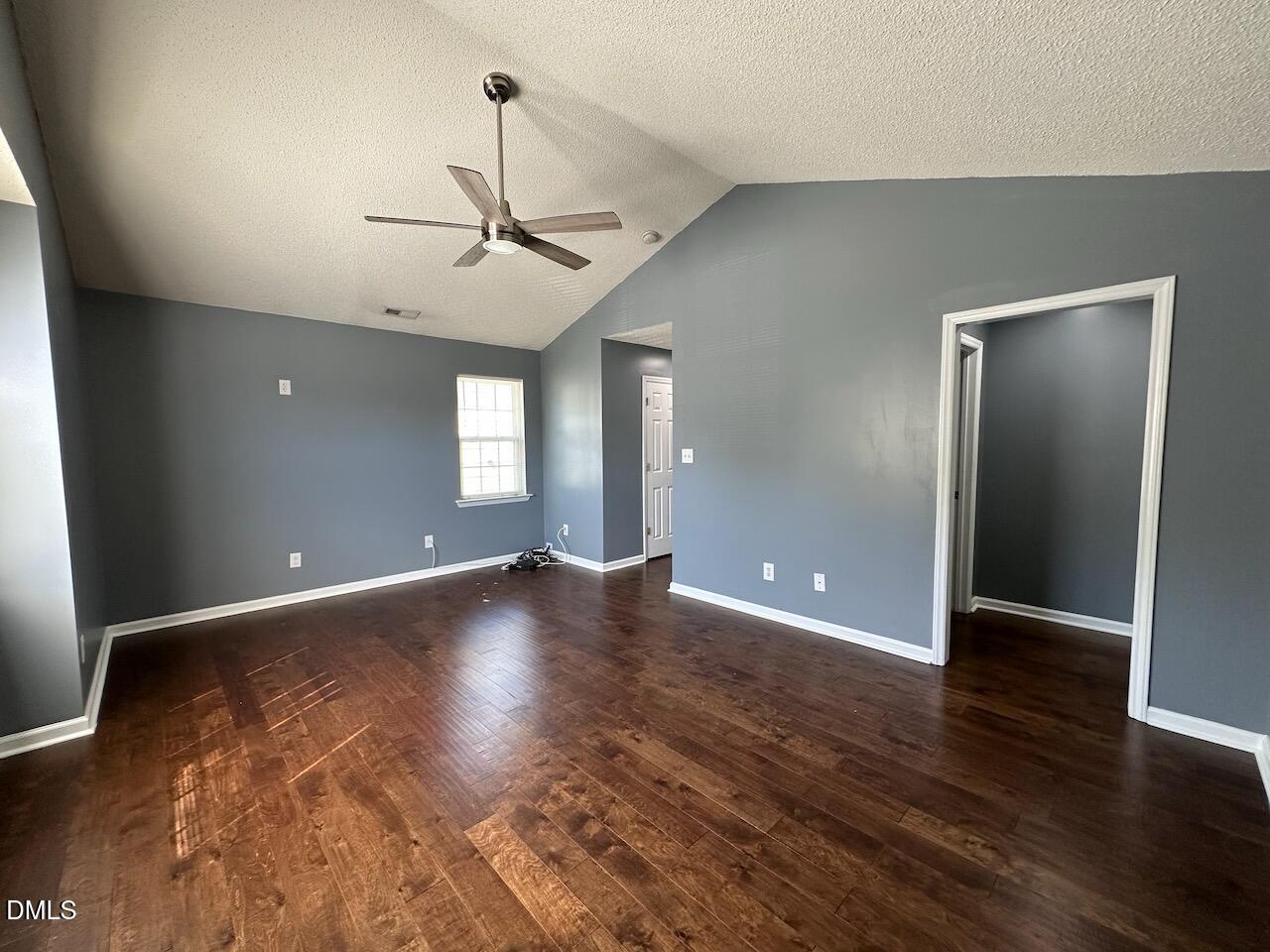 4617 Six Siblings Circle Raleigh, NC 27610 - Photo 14 of 35 an empty room with wooden floor and windows
