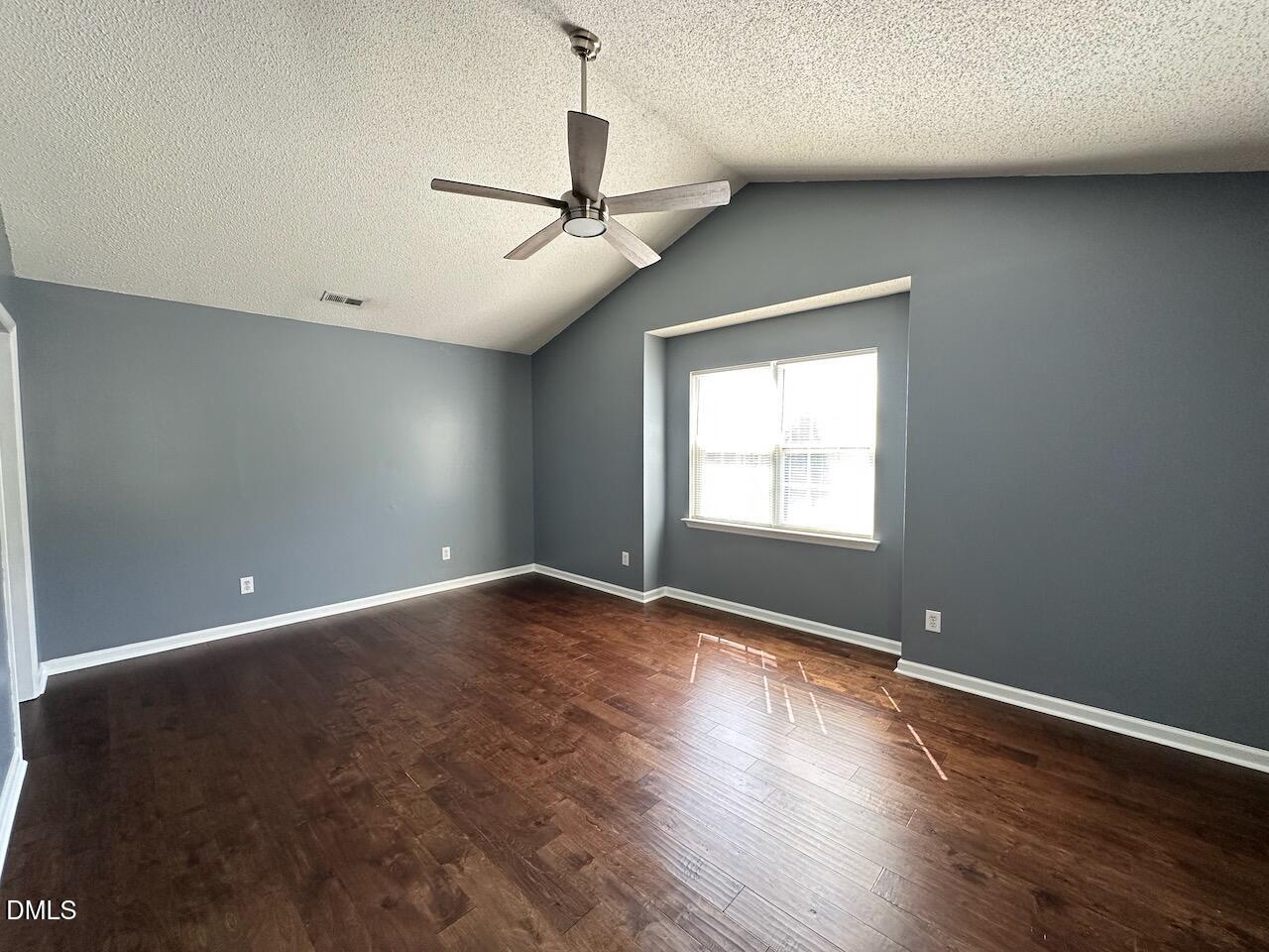 4617 Six Siblings Circle Raleigh, NC 27610 - Photo 15 of 35 a view of an empty room with wooden floor and a window