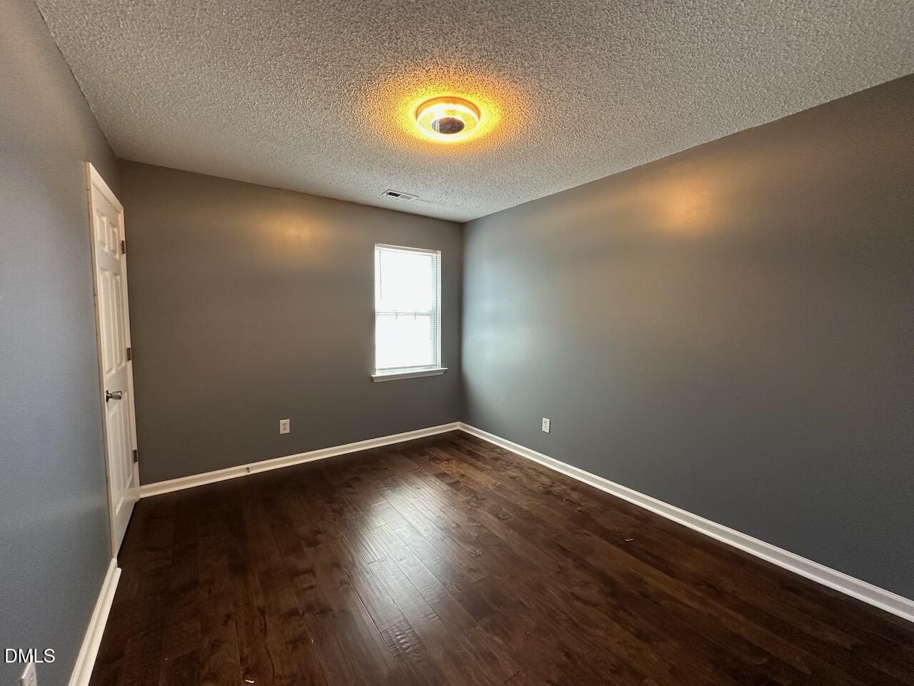 4617 Six Siblings Circle Raleigh, NC 27610 - Photo 19 of 35 an empty room with wooden floor and windows