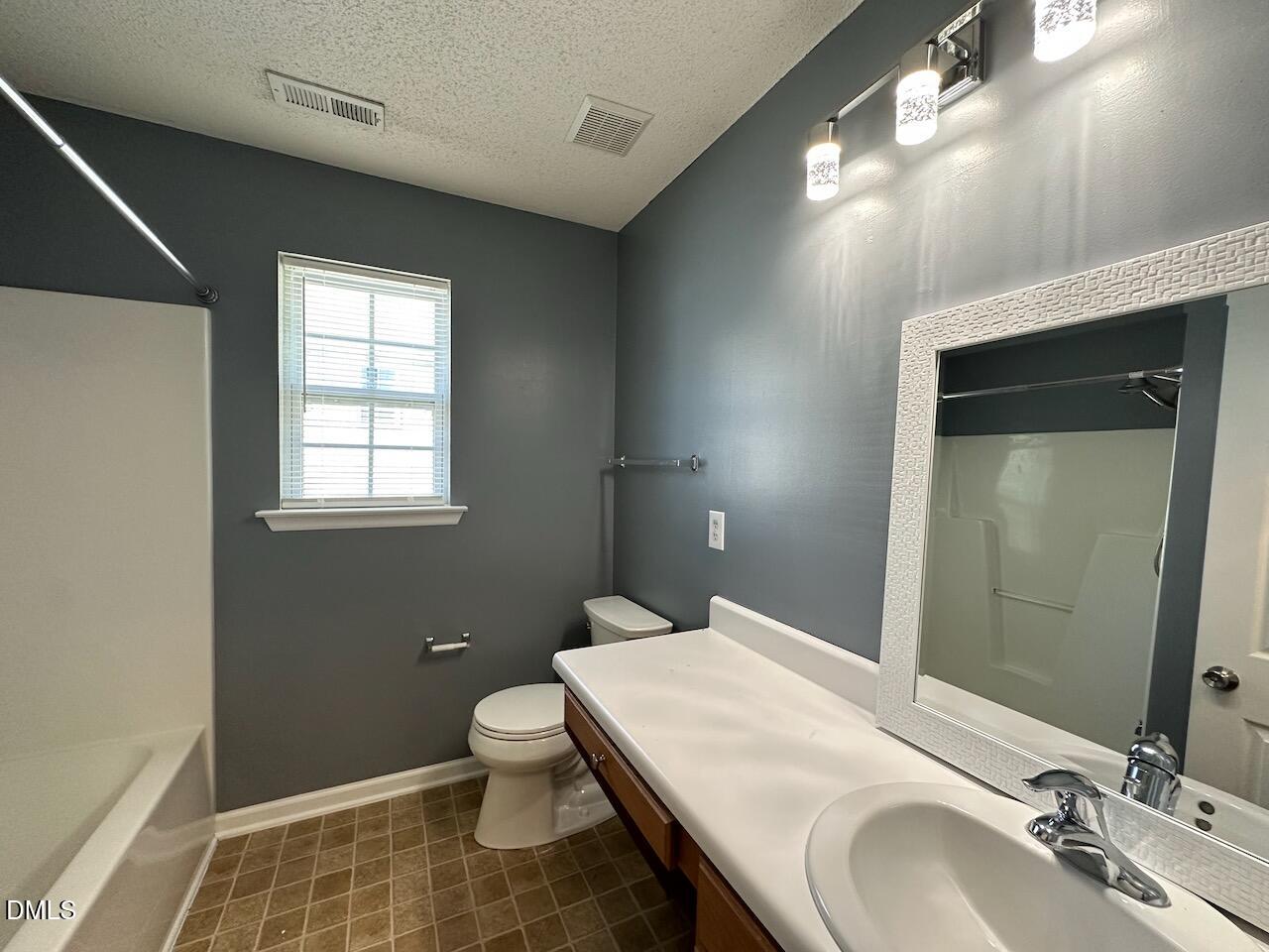 4617 Six Siblings Circle Raleigh, NC 27610 - Photo 21 of 35 a bathroom with a sink a toilet and shower