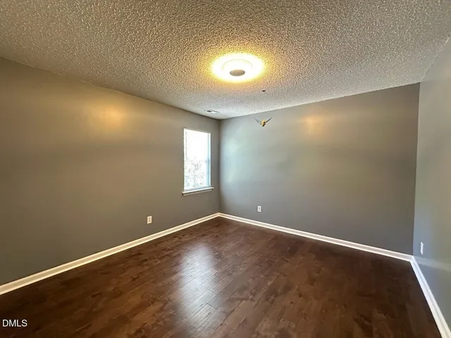 an empty room with a ceiling fan and fan