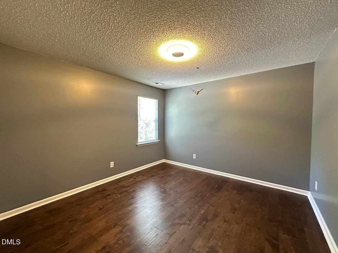 4617 Six Siblings Circle Raleigh, NC 27610 - Photo 23 of 35 an empty room with wooden floor and windows