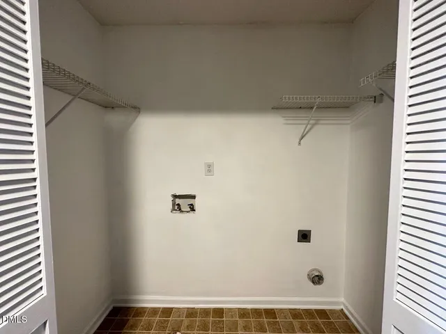 a view of a backyard with plants and patio