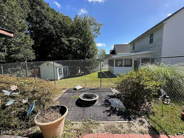 a view of a house with backyard and sitting area