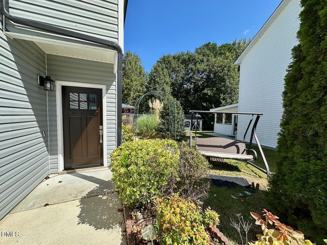 4617 Six Siblings Circle Raleigh, NC 27610 - Photo 3 of 35 a front view of a house with garden