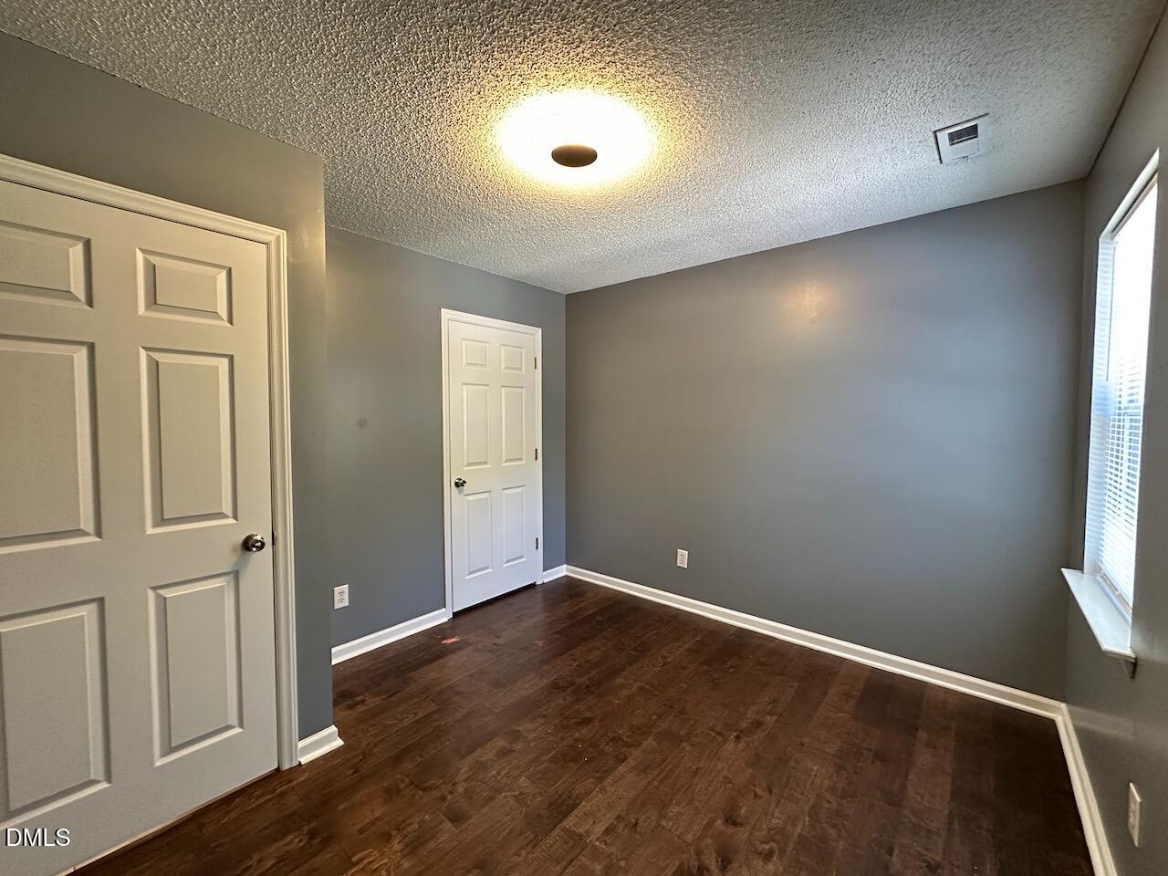 4617 Six Siblings Circle Raleigh, NC 27610 - Photo 33 of 35 an empty room with wooden floor and windows