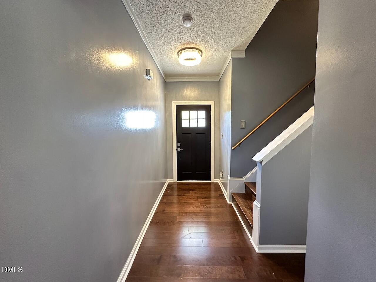 4617 Six Siblings Circle Raleigh, NC 27610 - Photo 4 of 35 a view of a hallway with wooden floor and staircase