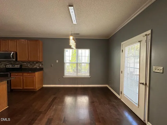a view of wooden floor and windows in a room