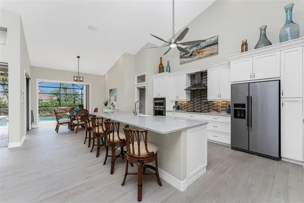 a kitchen with stainless steel appliances granite countertop a stove a sink and a refrigerator